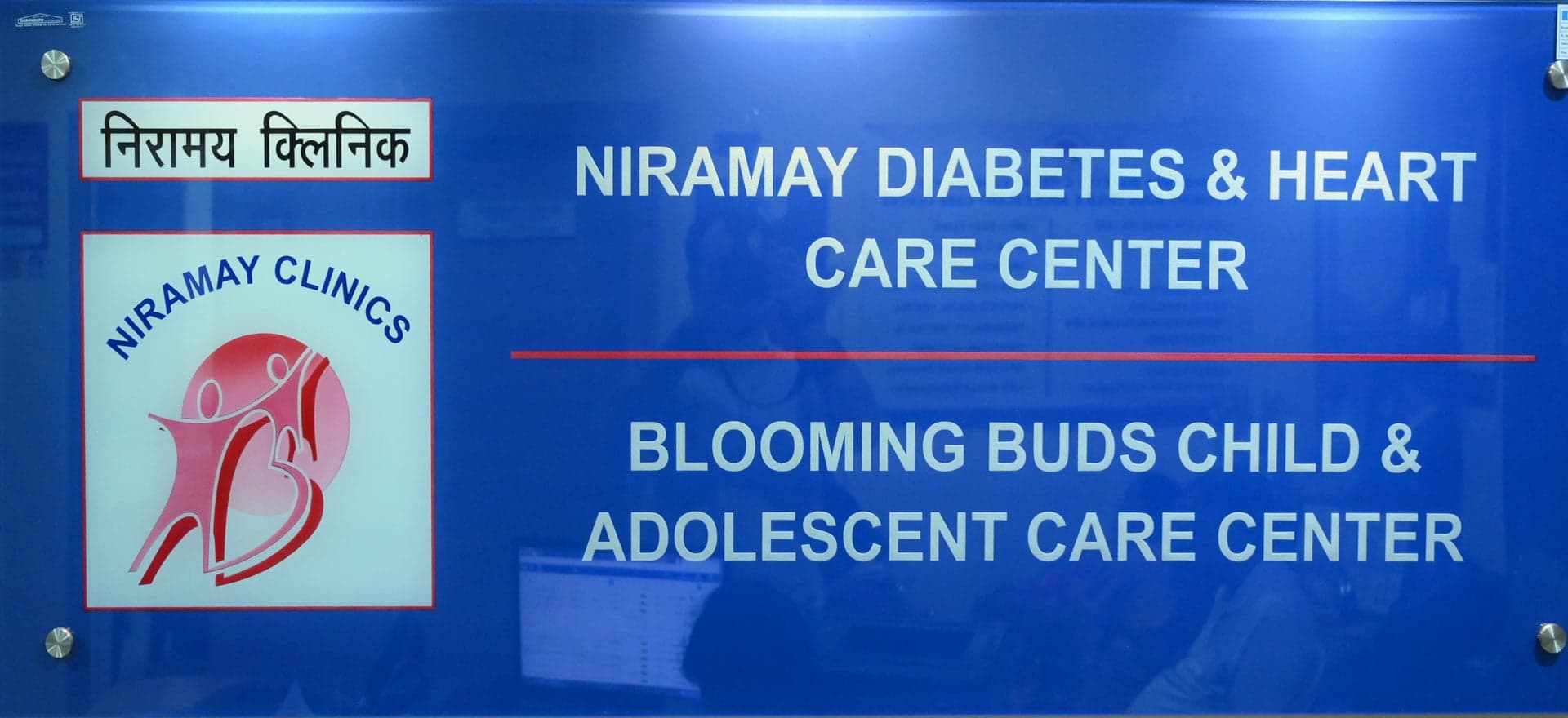 The Niramay Clinics reception board showing both centre names