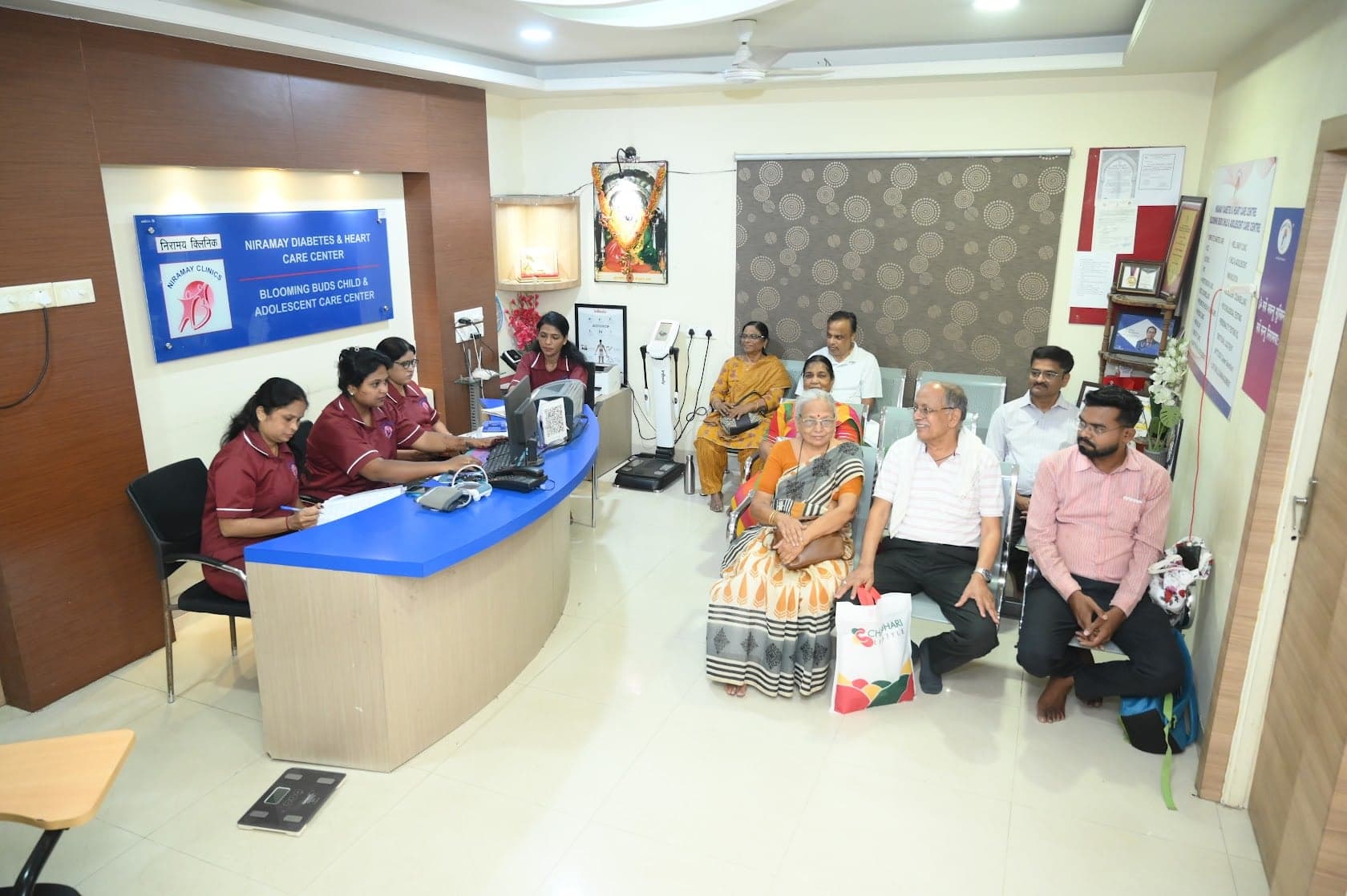 The Niramay Clinics waiting lounge and reception desk with the centre names board
